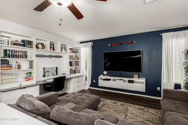 living room featuring ceiling fan, dark hardwood / wood-style flooring, and a healthy amount of sunlight