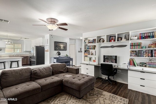 living room featuring ceiling fan and dark wood-type flooring