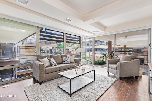 living room with floor to ceiling windows, wood-type flooring, and a wealth of natural light