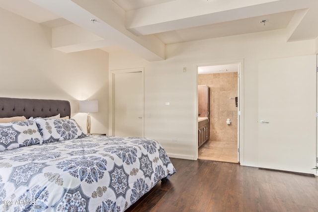 bedroom with dark wood-type flooring and connected bathroom