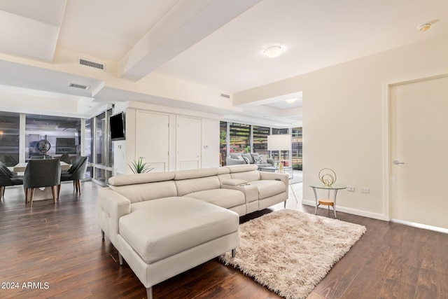 living room with beam ceiling and dark wood-type flooring