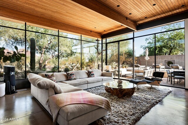 sunroom / solarium featuring beam ceiling, a wealth of natural light, and wood ceiling