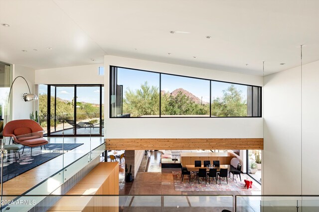 living room featuring a mountain view and lofted ceiling