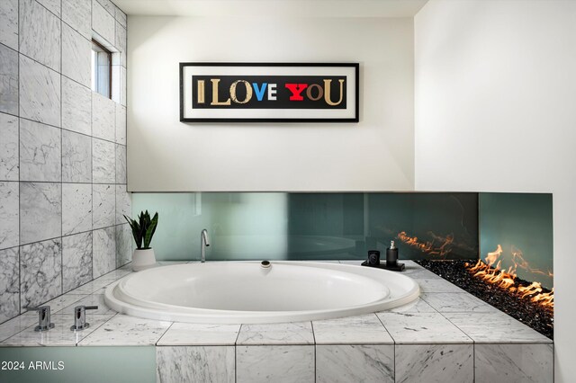 bathroom with a relaxing tiled tub