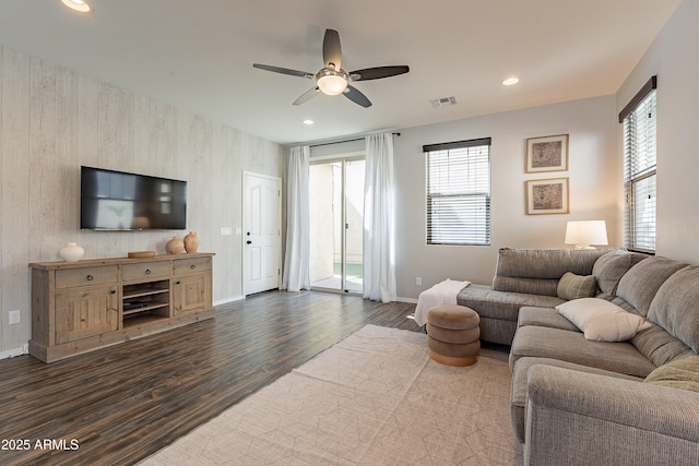 living area with ceiling fan, recessed lighting, dark wood-style flooring, visible vents, and baseboards