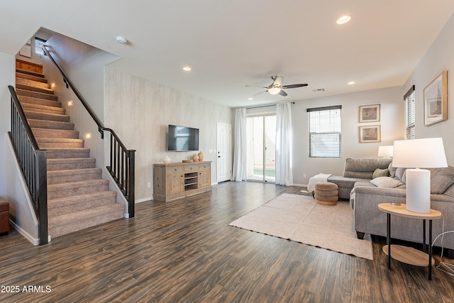 living room with recessed lighting, stairway, baseboards, and wood finished floors