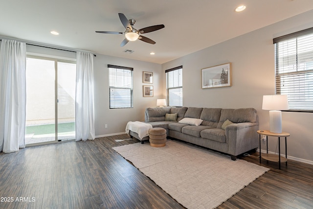 living area featuring recessed lighting, dark wood finished floors, visible vents, and baseboards