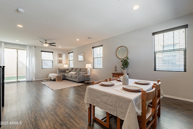 dining space featuring a healthy amount of sunlight, dark wood-type flooring, and recessed lighting