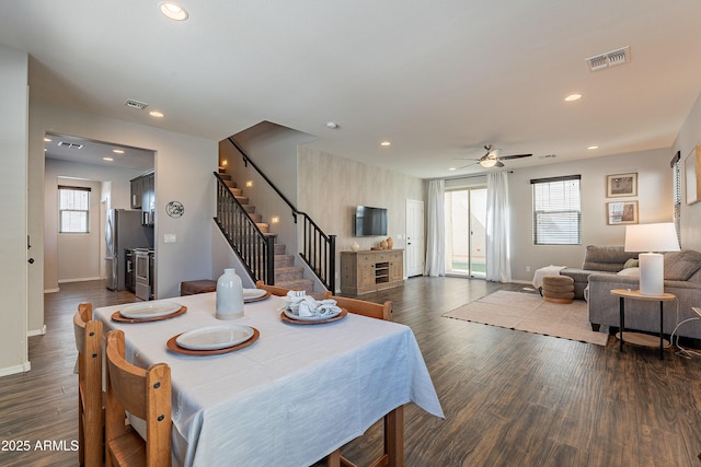 dining room featuring dark wood-type flooring, stairway, visible vents, and recessed lighting