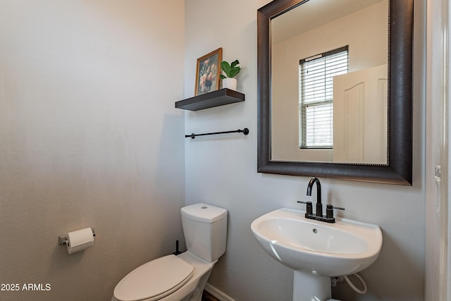 half bath featuring a sink and toilet