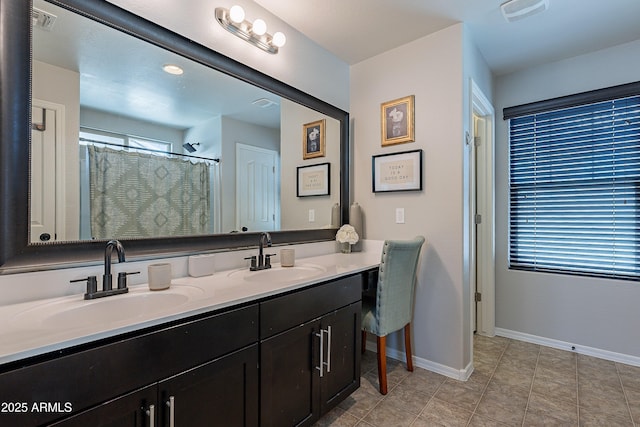 bathroom featuring a sink, visible vents, and baseboards