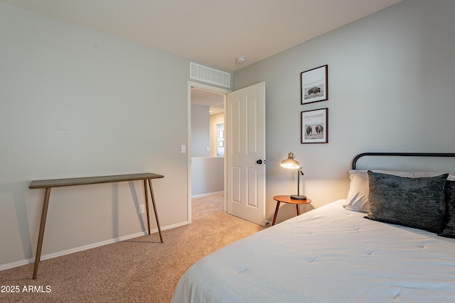 carpeted bedroom with visible vents and baseboards