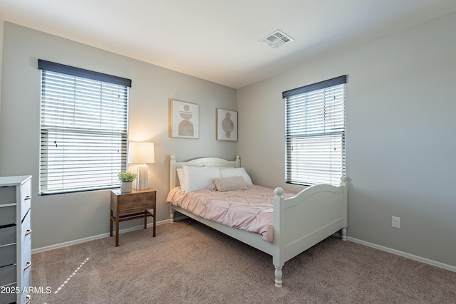 carpeted bedroom with visible vents and baseboards