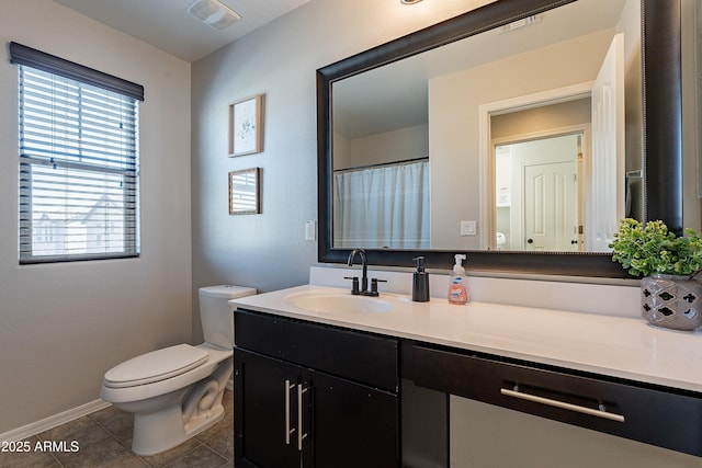 bathroom with baseboards, visible vents, toilet, tile patterned floors, and vanity