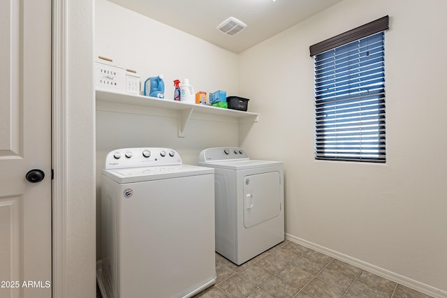 clothes washing area featuring laundry area, baseboards, visible vents, and washer and dryer