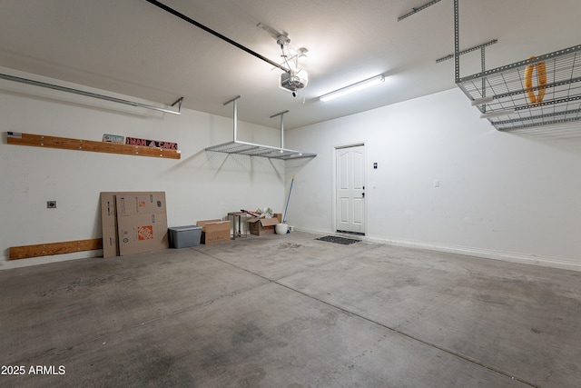 garage with baseboards and a garage door opener