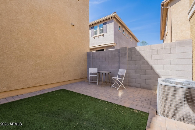 view of patio / terrace with central AC and fence