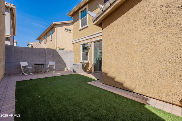 view of yard with fence and a patio