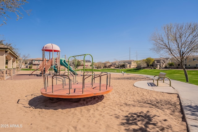 community playground with a residential view and a lawn