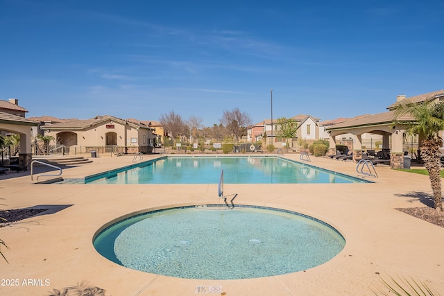 community pool with a residential view, a patio area, fence, and a gazebo