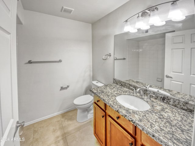 bathroom with oversized vanity, toilet, and tile floors