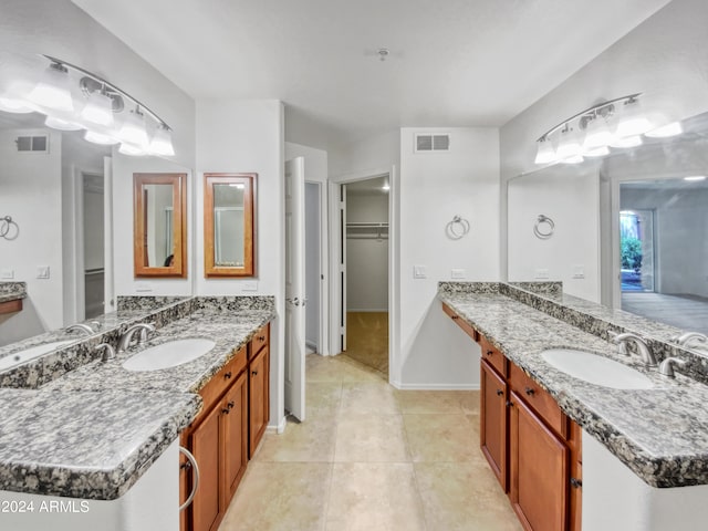 bathroom with tile flooring and double vanity