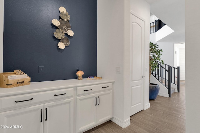 interior space featuring light hardwood / wood-style flooring and white cabinetry