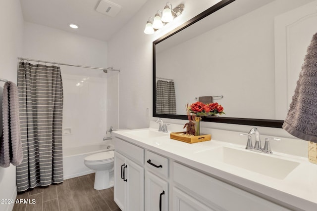 full bathroom with vanity, toilet, shower / bathtub combination with curtain, and hardwood / wood-style flooring