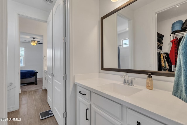 bathroom with ceiling fan, vanity, and hardwood / wood-style flooring