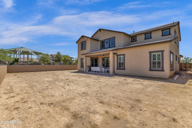 rear view of house with a patio and ceiling fan