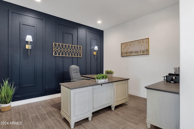 home office with light hardwood / wood-style floors