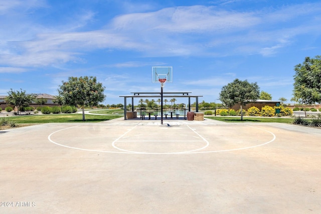 view of sport court featuring a lawn