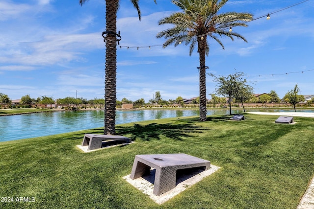 view of property's community featuring a water view and a lawn