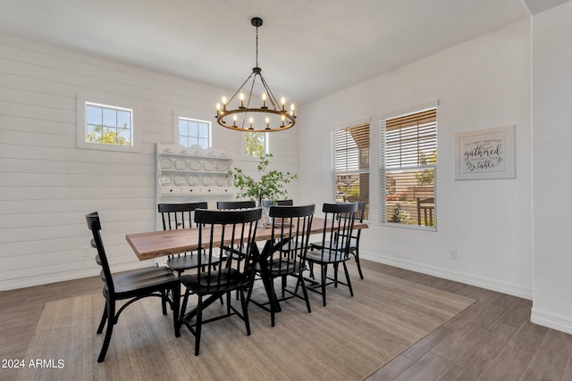 dining space featuring plenty of natural light, hardwood / wood-style floors, and a notable chandelier