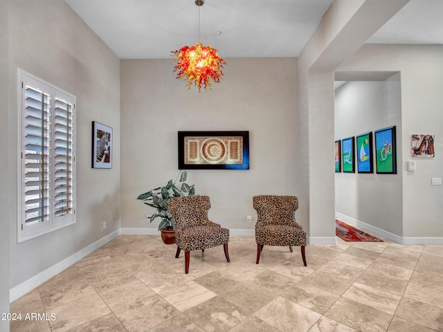 living area featuring an inviting chandelier