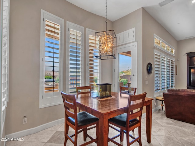 dining space with a healthy amount of sunlight, light tile patterned floors, and a chandelier