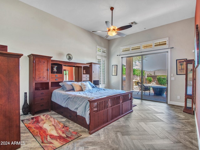 bedroom with light parquet floors, access to outside, a high ceiling, and ceiling fan