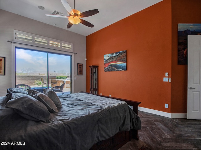 bedroom featuring ceiling fan, dark parquet floors, and access to outside