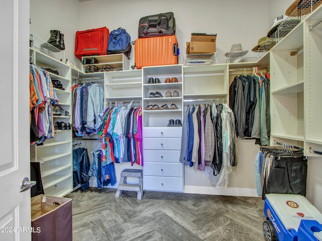 walk in closet featuring parquet flooring