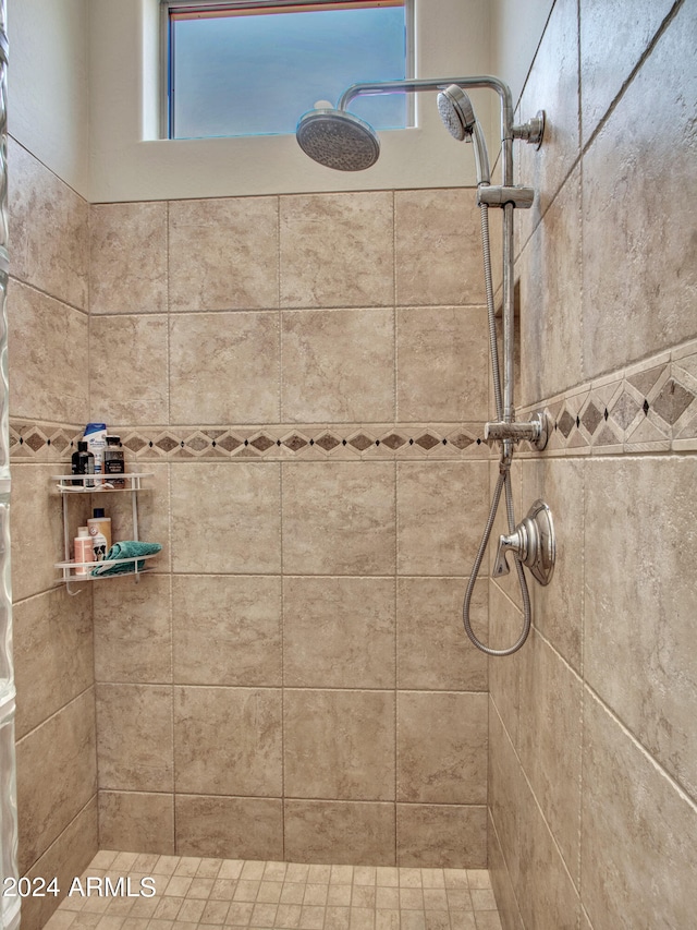 bathroom with tiled shower