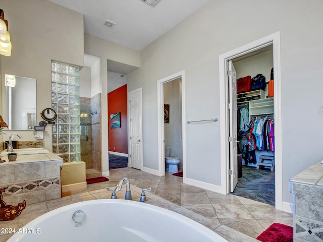 full bathroom featuring separate shower and tub, vanity, and toilet