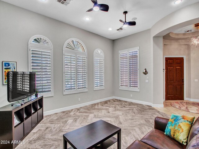 living area with ceiling fan and light parquet floors