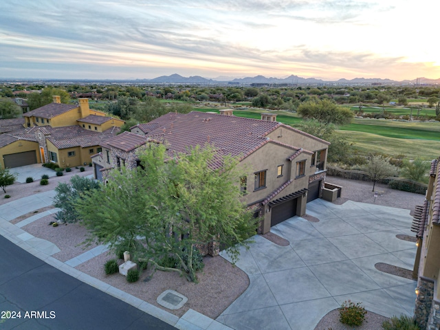 aerial view at dusk featuring a mountain view