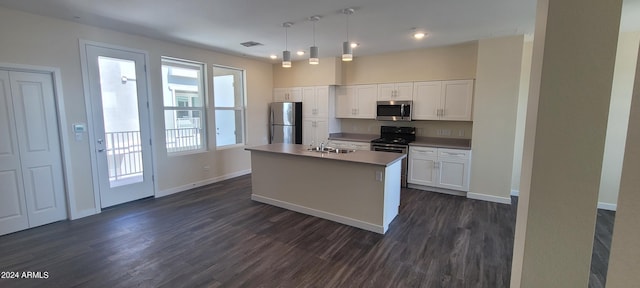 kitchen with appliances with stainless steel finishes, dark wood-type flooring, a sink, and white cabinets