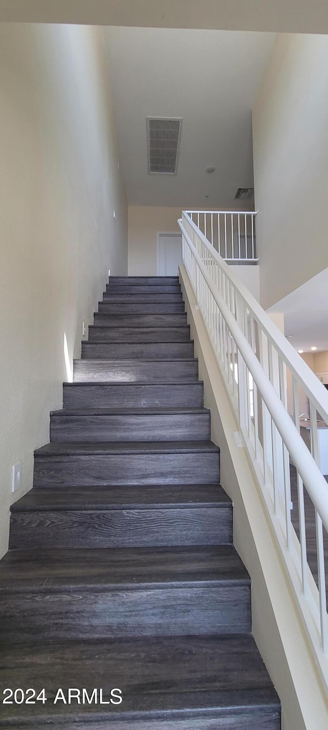 staircase featuring visible vents