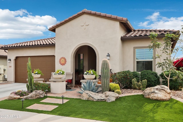 mediterranean / spanish-style home featuring a front lawn and a garage