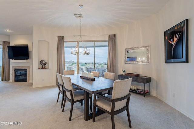 carpeted dining space featuring an inviting chandelier