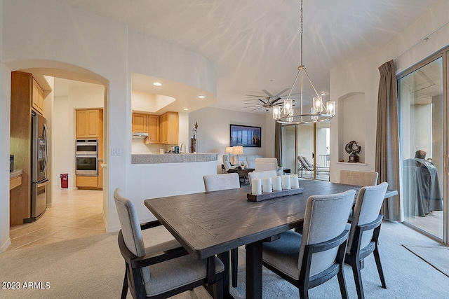 dining space featuring light carpet and a chandelier