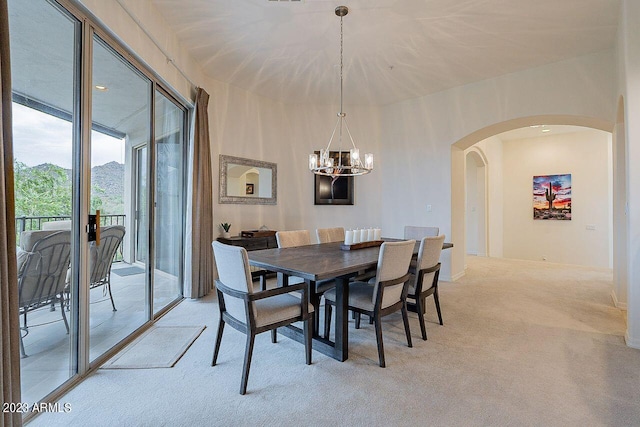 carpeted dining room featuring a chandelier