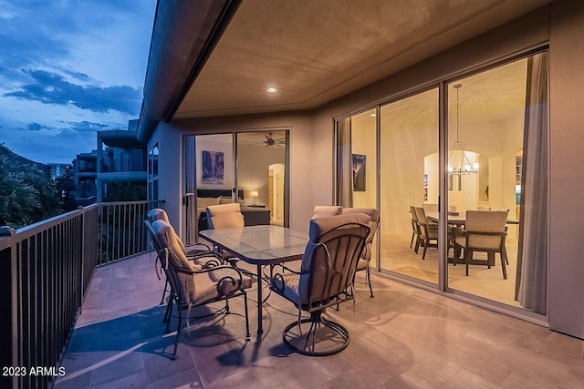 balcony at dusk featuring a mountain view